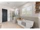 Bathroom features a soaking tub with tile surround, walk-in shower, and natural light at 125 Whitman Grv, Fayetteville, GA 30215