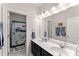 Bathroom with double sinks, marble countertops, a large mirror, and a tub-shower combo at 125 Whitman Grv, Fayetteville, GA 30215
