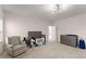Bright room with neutral carpet and a crib with a stuffed animal and a changing table at 125 Whitman Grv, Fayetteville, GA 30215