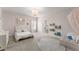 bedroom with adjacent bathroom, decorative lighting, neutral carpet and cute decor at 125 Whitman Grv, Fayetteville, GA 30215