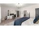 Bright bedroom area with stylish bed, desk space, and closet storage at 125 Whitman Grv, Fayetteville, GA 30215