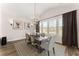 Cozy dining room with an elegant chandelier and large windows providing great natural light at 125 Whitman Grv, Fayetteville, GA 30215