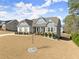 Attractive home featuring stone accents, shutters, a covered porch, and a spacious front yard at 125 Whitman Grv, Fayetteville, GA 30215