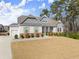 Attractive home featuring a two-car garage, stone accents, and well-maintained landscaping at 125 Whitman Grv, Fayetteville, GA 30215