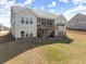View of backyard featuring a covered porch with stairs on a two-story home, with a fenced yard and manicured lawn at 125 Whitman Grv, Fayetteville, GA 30215