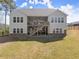 A well-maintained two-story home features a backyard with a covered porch and staircase, perfect for outdoor living at 125 Whitman Grv, Fayetteville, GA 30215
