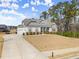 Charming home with a two-car garage, stone accents, landscaping, and well-maintained lawn at 125 Whitman Grv, Fayetteville, GA 30215