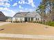 Inviting home featuring stone accents, shutters, a covered porch, and a green lawn at 125 Whitman Grv, Fayetteville, GA 30215