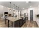 Open floor plan with large kitchen island and barstool seating that overlooks the living area at 125 Whitman Grv, Fayetteville, GA 30215