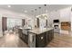 Open concept kitchen with stainless steel appliances, large island, and views into the living room at 125 Whitman Grv, Fayetteville, GA 30215