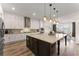 Well-equipped kitchen with a large center island, pendant lights, and stainless steel appliances at 125 Whitman Grv, Fayetteville, GA 30215