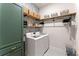 Laundry room features updated appliances, stylish storage, and tile flooring at 125 Whitman Grv, Fayetteville, GA 30215