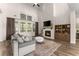 Bright living room features a fireplace, built-in shelving, and large windows for plenty of natural light at 125 Whitman Grv, Fayetteville, GA 30215