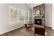 Living room features a stone fireplace, lots of natural light, and hardwood floors at 125 Whitman Grv, Fayetteville, GA 30215