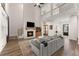 Open living room with fireplace and a large staircase leading to the upstairs balcony at 125 Whitman Grv, Fayetteville, GA 30215