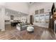 Open-concept living room with kitchen view, hardwood floors, and cozy seating area at 125 Whitman Grv, Fayetteville, GA 30215