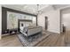 A luxurious main bedroom features a decorative rug, hardwood floors, and lots of natural light at 125 Whitman Grv, Fayetteville, GA 30215
