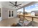 Large, covered patio overlooking backyard features comfortable seating and ceiling fan at 125 Whitman Grv, Fayetteville, GA 30215