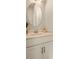 Modern half-bathroom with a round mirror, neutral countertop, and cabinets at 2030 Main Nw St # 207, Atlanta, GA 30318