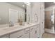 Bathroom with dual vanity sinks, white cabinets, mirror, and a glass shower at 2030 Main Nw St # 207, Atlanta, GA 30318