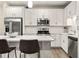 Bright kitchen featuring stainless steel appliances, a subway tile backsplash, and ample counter space at 2030 Main Nw St # 207, Atlanta, GA 30318