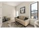 Comfortable living room with leather couch, hide rug, modern decorations and large window at 2030 Main Nw St # 207, Atlanta, GA 30318