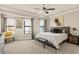 Neutral main bedroom features carpet, fan, and many windows with curtains at 2030 Main Nw St # 207, Atlanta, GA 30318