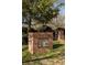 Whittier Mill Park entrance featuring a brick structure with a commemorative plaque and lush greenery at 2030 Main Nw St # 207, Atlanta, GA 30318