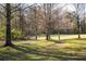 Expansive grassy area in the park, surrounded by trees, creating a tranquil outdoor space at 2030 Main Nw St # 207, Atlanta, GA 30318