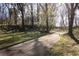 Picturesque walking path through the park, surrounded by mature trees and lush green grass at 2030 Main Nw St # 207, Atlanta, GA 30318