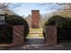 Historical brick water tower viewed from the park entrance with stone pathway and landscaped greenery at 2030 Main Nw St # 207, Atlanta, GA 30318