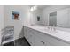 Bright bathroom with dual sinks, gray cabinets, modern fixtures, and a separate toilet room at 5018 Towneship Creek Rd, Roswell, GA 30075