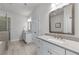 Modern bathroom with dual sink vanity, large mirror, quartz countertops, and neutral paint at 5018 Towneship Creek Rd, Roswell, GA 30075