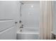 Bathroom showcasing a white shower over bath with sleek fixtures and neutral design at 5018 Towneship Creek Rd, Roswell, GA 30075