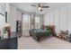A bedroom with paneled accent wall, large windows, ceiling fan, and toys throughout at 5018 Towneship Creek Rd, Roswell, GA 30075