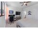 A well-lit bedroom showcasing a ceiling fan and an entertainment setup with TV and gaming monitors at 5018 Towneship Creek Rd, Roswell, GA 30075