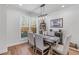 Cozy dining area features a table, seating for six, a pendant light fixture, and a large window for natural light at 5018 Towneship Creek Rd, Roswell, GA 30075