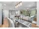 Bright, open-concept living space with a dining table, island kitchen, and adjoining living room at 5018 Towneship Creek Rd, Roswell, GA 30075