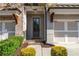 Inviting home exterior boasts gray brick, decorative brackets, and a well-manicured front garden at 5018 Towneship Creek Rd, Roswell, GA 30075