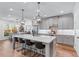 Spacious kitchen features a large island, stainless steel appliances, and stylish pendant lighting at 5018 Towneship Creek Rd, Roswell, GA 30075