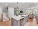 Open-concept kitchen with a central island, stainless steel appliances, and seamless connection to living spaces at 5018 Towneship Creek Rd, Roswell, GA 30075