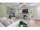 Cozy living room with a fireplace, comfortable seating, neutral tones, and an adjacent outdoor patio at 5018 Towneship Creek Rd, Roswell, GA 30075
