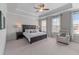 Bright main bedroom features trey ceiling, ceiling fan, and large windows overlooking the yard at 5018 Towneship Creek Rd, Roswell, GA 30075