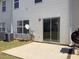 Back patio with sliding door and grass area, complete with barbecue grill for outdoor enjoyment at 7229 Georges Way, Morrow, GA 30260