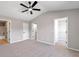 Large bedroom with ceiling fan and multiple doors including a closet and bathroom entrance at 7229 Georges Way, Morrow, GA 30260