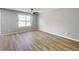 Spacious bedroom with hard surface flooring and large window offering ample natural light. Ceiling fan included at 7229 Georges Way, Morrow, GA 30260