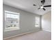 Bright bedroom featuring two windows that let in natural light and neutral colored walls at 7229 Georges Way, Morrow, GA 30260