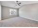 Spacious bedroom featuring neutral carpet, vaulted ceiling with fan, and bright window overlooking the neighborhood at 7229 Georges Way, Morrow, GA 30260
