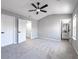 Large bedroom with neutral walls, carpet flooring, ceiling fan and an ensuite bathroom at 7229 Georges Way, Morrow, GA 30260