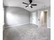Spacious bedroom with gray walls, a ceiling fan, and plush carpeting for comfort at 7229 Georges Way, Morrow, GA 30260